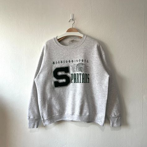 Excited to share this item from my #etsy shop: Vintage 90s Michigan State University Spartans Crewneck Sweatshirt (XL) Vintage College Sweatshirt, Thermal Hoodie, Michigan State University, Gray Sweatshirt, Embroidered Crewneck, Michigan State, How To Make Shorts, Tour T Shirts, Grey Sweatshirt