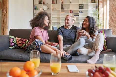 Smiling group of diverse young friends wearing pajamas talking together on their living room sofa Friends On Couch, Group Cuddle, Couch Photoshoot, Group Reference, Laughing Friends, Y2k Friends, Friendship Photo, Christ Centered Marriage, Friends Hanging Out