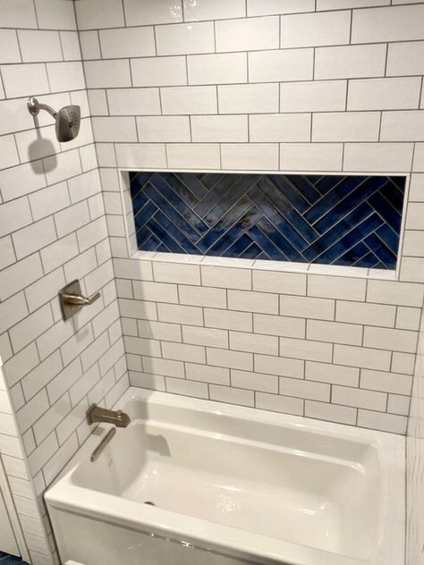 White 4x10 subway tile with a blue 3x12 in the niche and on the bath floor. Bathroom Tile Ideas Shower Tub Surround Blue, Subway Tile Around Bathtub, White Tile Shower With Blue Accent, Blue Shower Niche, Auburn Bathroom, Blue Subway Tile Bathroom, Barndo Interior, Guess Bathroom, Tile Around Bathtub