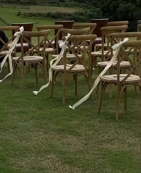 Alternative Wedding Aisle, White Chair Bows Wedding, White Garden Chairs Wedding Ceremony, Garden Wedding Chairs, Wedding Aisle No Flowers, Ribbon Aisle Markers, Chair Markers For Wedding, Minimal Wedding Aisle, Ribbon Aisle Decor