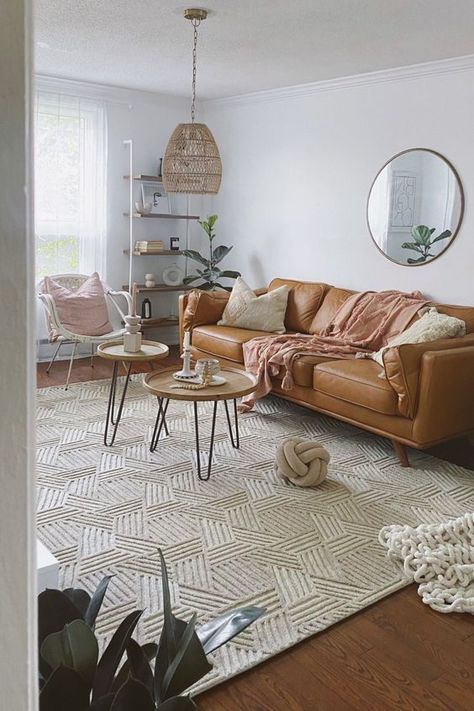 Picture of a boho living room with a tan leather sofa, coffee tables, a rattan chair, a shelving unit and a pendant lamp plus a cool big rug Tan Couch Living Room, Tan Couch, Tan Living Room, Leather Couches Living Room, Brown Couch Living Room, Modern Boho Living Room, Leather Sofa Living Room, Couch Living Room, Modern Home Interior Design