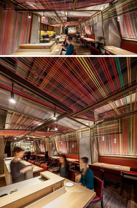 El Equipo Creativo have designed the Pakta Restaurant in Barcelona, Spain, that features an interior with brightly colored ropes. #InteriorDesign #RestaurantDesign #Rope #Ceiling Restaurants Ceiling Design, Ceiling Design Restaurant, Bar Ceiling Design, Rustic Restaurant Interior, Colorful Ceiling, Rope Ceiling, Mexican Restaurant Decor, Restaurant Ceiling, Ceiling Feature