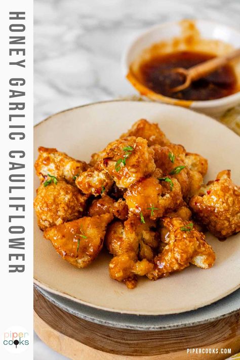 Craving something crunchy and delicious? This air fryer honey garlic cauliflower recipe is the answer. Crispy, flavorful cauliflower that's a breeze to make in the air fryer. Tossed in a sweet and savory honey garlic sauce, this dish is a veggie lover's dream. Perfect as a side or snack on game day, and quick enough for weeknight dinners, it's sure to be a hit with the whole family. How To Cook Cauliflower, Cauliflower Bread, Honey Garlic Sauce, Cauliflower Bites, Sauteed Chicken, Honey Garlic Chicken, Toasted Sesame Seeds, Honey Garlic, Garlic Chicken