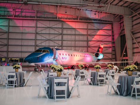 An Air Hangar Holiday Party Airplane Hanger Wedding, Airplane Hangar Wedding, Hangar Wedding, Airplane Hangar, Holiday Salads, Airplane Decor, Christmas 2025, Festive Cocktails, Food Stations