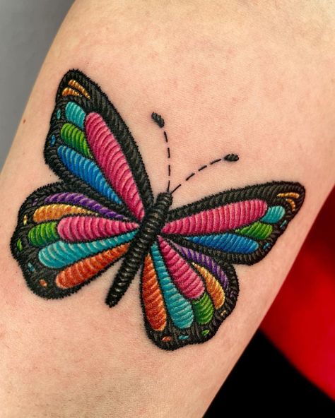 30 Embroidery Tattoos That Show Off This Emerging Trend | Have you seen these cool embroidery tattoos yet? Lifestyle Butterfly Embroidery Tattoo, Cool New Tattoo Ideas, Embroidery Butterfly Tattoo, Stitch Work Tattoo, Embroided Tattoos, Tattoo That Looks Like Embroidery, Small Embroidery Tattoo Ideas, Pach Tattoo Ideas, Mexican Embroidery Tattoo Ideas