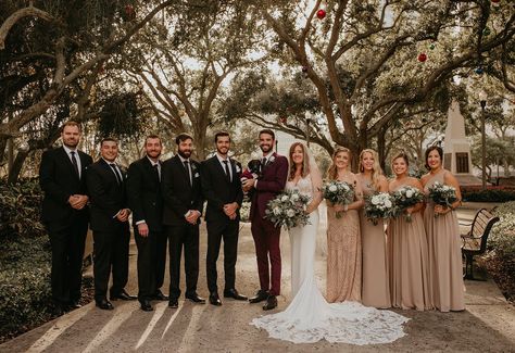 Bridal Party Portrait | Bridesmaids in Neutral Taupe Tan and Groomsmen Black with Burgundy Groom's Suit Burgundy Grooms Suit, Burgundy Groom Suit Wedding Inspiration, Groom Suit Burgundy Wedding Colors, Burgundy And Taupe Wedding, Wedding Party Black Suits, Burgundy And Tan Wedding Party, Maroon Groom Suit Wedding Inspiration, Bridesmaid And Groomsmen Pictures Color Schemes, Burgundy Groom Suit And Groomsmen