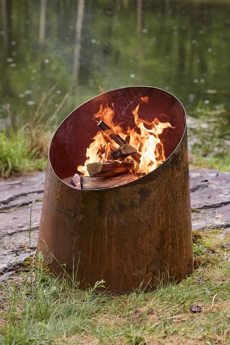 This angled opening cylindrical fire pit is forged from corten weathering steel that develops a protective rust-like patina that shields the underlying metal. 🔥 Plant Troughs, Outdoor Fire Pit Seating, Fire Places, Fire Pit Bowl, Outdoor Living Furniture, Weathering Steel, Mirror House, Living Essentials, Backyard Fire