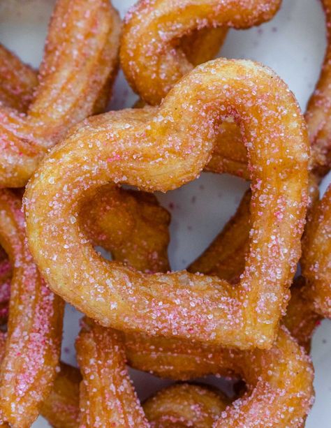 Heart-Shaped Churros with a thick chocolate sauce - Apron & Whisk Hot Chocolate Sauce, Churros Recipe, Choux Pastry, Pink Chocolate, Valentine's Day Recipes, Red Food Coloring, Chocolate Cinnamon, Red Food, Chocolate Sauce