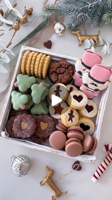 Yukiko Tanzi on Instagram: "Christmas cookie box 🌲🩷
I love how it turned out this year 🥹

Here's what's in the box: 
✨Vanilla cookie sandwiches 
✨Brownie crinkle cookies 
✨Nutcracker macarons 
✨Christmas tree macarons with caramel filling 
✨Linzer cookies 
✨Chocolate and Nutella Linzer cookies 
✨Chocolate macarons 

All the recipes are posted in previous posts. ✨

#christmascookiebox #christmasbaking #christmas #cookies #holidays #holidaybaking" Christmas Linzer Cookies, Christmas Macarons, Christmas Cookie Box, Linzer Cookies, Crinkle Cookies, Vanilla Cookies, Cookie Box, Sandwich Cookies, Chocolate Cookies