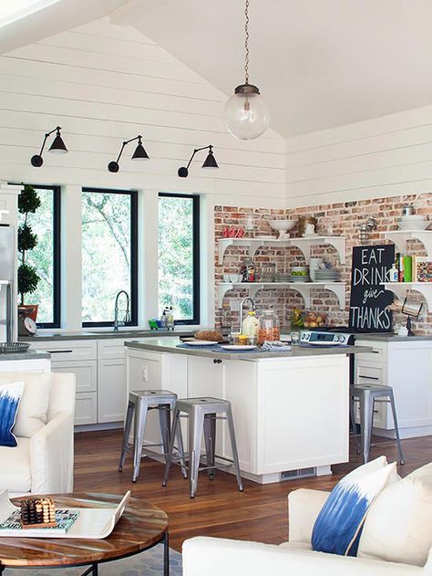 Give a new space a sense of history by opting for weathered, reclaimed brick. In this kitchen, corner shelves let the brick take center stage while prompting organization. Board Backsplash Kitchen, Board Backsplash, Windows Farmhouse, Brick Wall Ideas, Brick Backsplash Kitchen, Raw Texture, Farmhouse Flair, Industrial Style Kitchen, Loft Stil