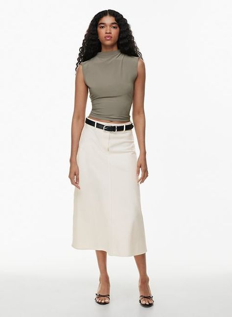 The Under-$100 Aritzia Basics That Will Last Forever in Your Wardrobe | Who What Wear Aritzia Basics, Long Tube Top, Perfect White Tee, Elevated Basics, Satin Midi Skirt, Pleated Shorts, Pleated Midi Skirt, Halter Style, Fashion Editor