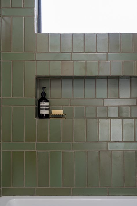 Heath Ceramics green tile in a bathroom designed by Stay Interiors. Green Rectangle Tile Bathroom, Heath Tile Backsplash, Green Tile Bath Shower Combo, Heath Ceramics Bathroom, Green Tile Brown Grout, Two Tone Bathroom Tiles, Heath Tile Kitchen, Green Primary Bathroom, Heath Tile Bathroom