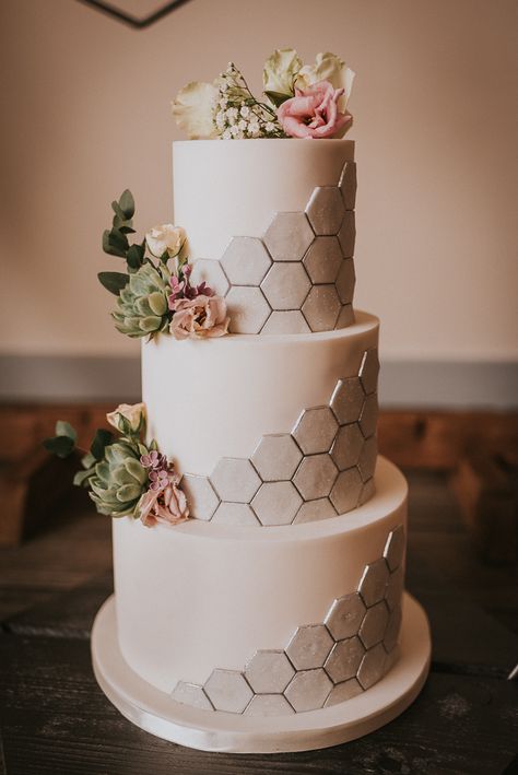 Three Tier White Wedding Cake with Silver Hexagonal Honeycomb Effect | Photographer: Grace Nicole Photography | Styling Direction & Props: The Rustic Wedding Company | Venue: Swallow’s Next Barn | Florist: Lilac & Wild | Cakes: Deliciously Divine Cake Design | Props: Bramble Sky | Stationery: Jenna Claire Stationery | Makeup: Louise A’Ness Makeup Artist | Hair: Occassion Hair by Helen | Model: Ioana Matache | Wedding Dresses: Dress Me Pretty Bridal Room Hexagon Wedding Cake, Geometric Cake, Hexagon Wedding, Wedding Cake Prices, 3 Tier Wedding Cakes, Romantic Wedding Cake, Engagement Cakes, Modern Wedding Cake, White Wedding Cake