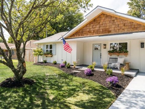 Curb appeal to the rescue: The house received a freshly painted board-and-batten exterior, upgraded landscaping, new exterior lighting, window boxes and natural cedar-shingle siding for the gable. The Marrs' also relocated the home's entry, so it's no longer crowded into a corner. 1980 Ranch House Remodel, Dave And Jenny Marrs, Colorful Landscaping, Brick Ranch Houses, Small Front Yards, Cedar Shingle Siding, Jenny Marrs, Trees For Front Yard, Shed Makeover