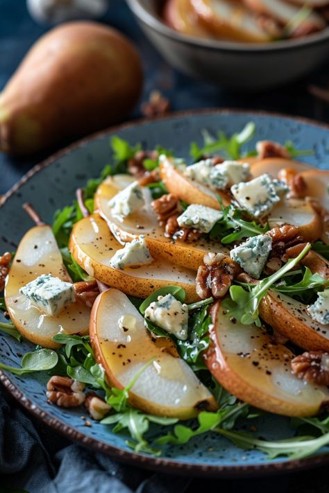 Sliced pear salad with arugula, blue cheese, and walnuts on a blue plate. Baked Pear Salad, Pears And Gorgonzola, Autumn Dinner Salad, Pear Recipes Salad, Pear Cheese Salad, Crisp Salad Recipes, Salad With Pears And Gorgonzola, Sweet And Savory Salad, Fall Recipes Side Dishes