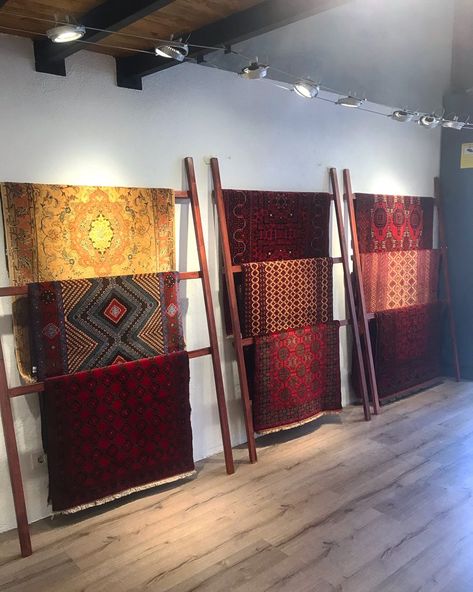 A display of handmade carpets at a handmade carpet gallery Rug Rack Display, Retail Rug Display, Textile Retail Store Design, Carpet Shop Interior Design, Carpet Display Ideas, Rug Display Ideas Retail, Carpet Store Design, Rug Display, Carpet Display