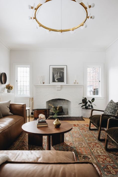 Brick fireplace in living room with brown leather couches, vintage rug, and round, wooden coffee table. Jean Stoffer Design, Jean Stoffer, Living Room Fireplace, Living Room Inspo, Living Room Inspiration, Home Living Room, See It, Room Inspiration, Living Room Designs