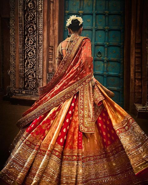 Bride Radhika Merchant wears @manishmalhotraworld @manishmalhotra05 Couture for her Vidai Ceremony!! ♥️ This exquisite blouse features real gold karchobi work, inspired by the traditional abho and the rich textile heritage of Kutch, Gujarat, echoing the artistry of the late 19th century. Paired with a multi-paneled Banarasi brocade lehenga in sunset hues, this ensemble is a tribute to India’s timeless elegance. A veil with a lattice design on a beautiful red complements the attire. The dupa... Dolly Jain, Radhika Merchant, Kutch Gujarat, Celebrity Wedding Photos, Brocade Lehenga, Banarasi Brocade, Sunset Hues, Big Fat Indian Wedding, Manish Malhotra