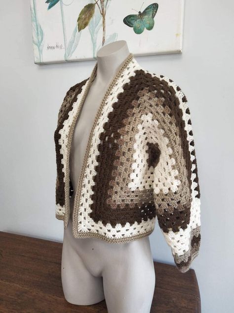 This lovely and warm crochet granny hexagon sweater or cardigan in warm earthy browns has been made using 100% acrylic yarn  Size: Aust. Small to medium  SEE MORE CARDIGANS OR SWEATERS HERE: https://www.etsy.com/your/shops/me/tools/listings/section:28856767,sort:title,order:ascending,stats:true MODEL'S MEASUREMENTS:  Bust- 87cm Under bust - 72cm Waist  - 62cm Hips - 82cm All items listed in my store are a finished product and are ready to be shipped immediately.   MADE IN A SMOKE FREE ENVIRONMEN Hexagonal Crochet Cardigan, Crochet Cardigan Brown, Hexagon Granny Square Cardigan, Hexagon Crochet Cardigan, Hexi Cardigan, Brown Crochet Cardigan, Crochet Granny Hexagon, Hexagon Cardigan Crochet, Hexagon Sweater