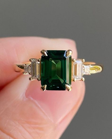 Five Stone Art Deco Diamond Ring, 2CT Green Emerald Center Engagement Ring, Princess & Baguette Cut Retro Ring, Gift For Her, 14K Gold Ring Item Description: Main Stone - Simulated Diamond Main Shape-  Emerald Cut  Side Stone- Simulated Diamond Side Stone Shap- Princess & Baguette 1. White Gold: 10K/14K/18K 2. Yellow Gold: 10K/14K/18K 3. Rose Gold: 10K/14K/18K 4. Silver: Sterling Silver 925 Size Customization: What Size you want... * You can also Customize ring size in US 4 to US 12! It sometime Moissanite And Emerald Engagement Ring, Emerald Engagement Ring Square, Emerald Princess Cut Ring, Green Emerald Ring Engagement, Emerald Gem Engagement Ring, Emerald Art Deco Ring, Emerald Cut Emerald Engagement Ring, Emerald Stone Engagement Ring, Emerald Green Engagement Ring