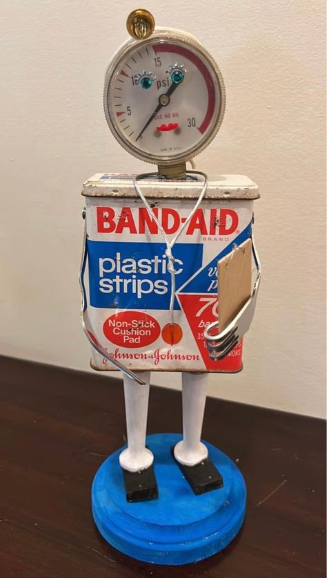 "These doctors are on duty! Made from vintage bandaid tins and other found objects, these little guys are sure to bring a smile! Each holds a little clipboard chart in his forked hand, has a tiny stethoscope around his neck and wears a sweet silver heart. Bandaid also has a tiny \"headlamp\". Great gift idea for your favorite physician! Choose from BandAid (stands approximately 10.5\" high) or Curad (stands 9\" high). Both are on a 4\" round base." Tin Can Robots, Found Object Sculpture, Repurposed Junk, Object Sculpture, Diy Recycled Projects, Assemblage Art Dolls, Tin Can Art, Recycled Art Projects, Robot Sculpture