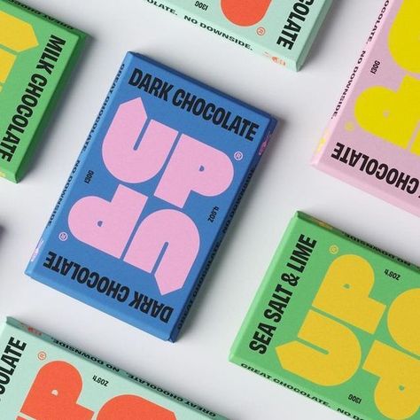 Pentawards on Instagram: "@freytaganderson's identity and packaging design for @upupchocolate. The symmetrical, fully rotatable design was created to physically represent the brands positive messaging. The impactful colour palette is inspired by the vibrancy of the Colombia where the cocoa is farmed, bringing with it some fun as well as a serious commentary on how the chocolate industry currently operates. #pentawards #packagingdesign #packagingdesigninspo #packaginginspiration #foodpackaging Fun Food Packaging, Color Palette Food Packaging Design, Modern Chocolate Packaging, Candy Branding Identity, Candy Packaging Design, Snacks Package, Chocolate Bar Branding, Candy Branding, Funky Packaging