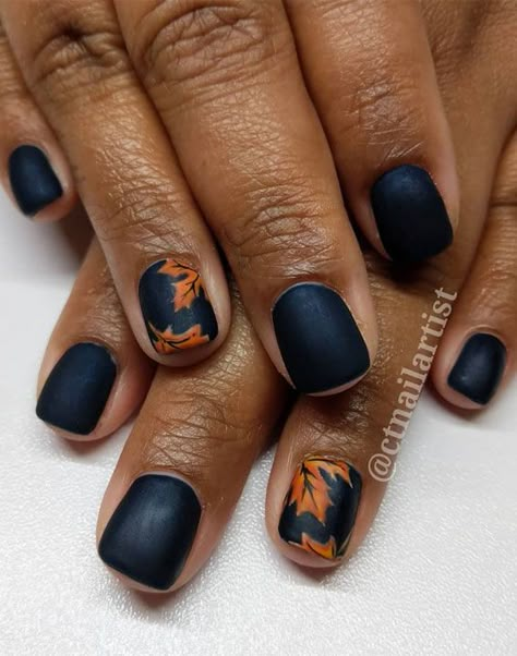 Navy blue nails Looking for stylish and easy to wear nail art? If so, this could be perfect for you. Gorgeous matte orange fall leaves... Brown And Navy Nails, Black Nails With Fall Leaves, Glitter Leaves Nails, Navy And Orange Nails Design, Navy Blue And Burnt Orange Nails, Navy Nails Fall, Blue Fall Nails 2022, Navy Blue Matte Nails Fall, Navy Autumn Nails