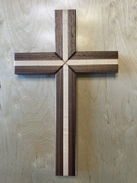 Beautiful handmade wooden wall cross with 2 different species of wood. It's made of Solid Walnut & Maple. This is not your average wooden cross, but rather a very nice collectors piece. The overall dimensions are 10"Wx16"H. The top, bottom, and sides are a thick 2" wide and 1" deep. These crosses are handmade by me and they are made to order. I start by glueing and clamping all pieces in which I let dry for 24 hours. I then plane and sand all surfaces to a smooth finish. The center is a mitered fit with a floating style glued bridle joint for extra strength to last a lifetime. All sides and center have a routered chamfered (beveled) edge followed with three coats of lacquer finish. Keyhole style hanging on the back which will hang with one screw or nail. There is No stain used on the cross Wooden Crosses Handmade, Picket Projects, Wooden Crosses Diy, Wood Crosses Diy, Handmade Wood Crafts, Wood Wall Cross, Bible Things, Woodworking Projects Furniture, Barn Wood Crafts