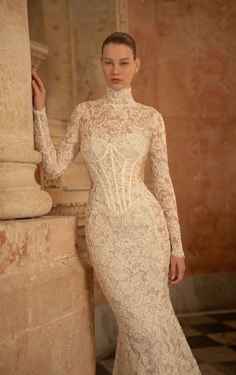 Lee Petra Grebenau Spring 2025 bridal collection. The Jazz wedding gown, a mermaid style featuring a dropped waist and sheer side panels, boasting a long, dramatic train crafted from French lace. Paired with a turtle neck, long sleeve bodysuit for added elegance. #leegrebenau #luxurybridal #bridal2025 #couturebridal #luxurywedding Wedding Dress Turtle Neck Lace, Long Sleeve Bustier Wedding Dress, Trumpet Dress With Sleeves, Lace Mock Neck Wedding Dress, Turtle Neck Lace Wedding Dress, Turtle Neck Wedding Gown, Long Sleeve Turtle Neck Wedding Dress, Long Sleeve Wedding Dress High Neck, Classy Lace Wedding Dress