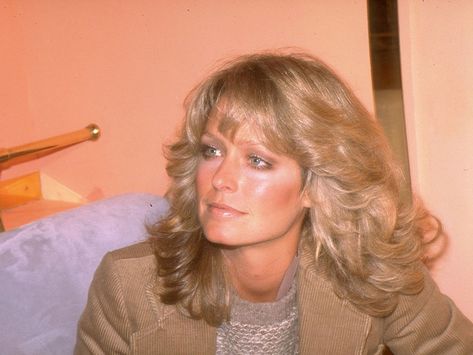 What goes around, comes around, and we're glad to see feathered hair is no exception. Ahead, 25 ways to wear feathery, '70s hair à la Farrah Fawcett. 70s Feathered Hair, 1970s Hairstyles, Feathered Hair, Donna Mills, Ryan O'neal, Feathered Bangs, 70s Hair, Kate Jackson, Hair Icon