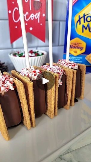 7.6K views · 990 reactions | Cozy up and crunch into the holiday season with these Peppermint S'more Pops! 🍫❄️ Your favorite s'mores reimagined on a stick, dipped in chocolate, and dusted with peppermint pieces for that extra winter wonder. Perfect for sharing and sure to make your spirits bright! 🌟 #peppermint #Smores #holidayvibes #TreatYourself #Reels #FoodieFeature #merry #smoresonastick | Nicole | Atlanta Custom Cakes | Robert D. Sands Jr. · Presents for Christmas Smores On A Stick, Smores Cake Pops, S’mores On A Stick, S'mores On A Stick, S'more On A Stick, Chocolate Dipped S’mores, Smores Christmas, S’more Marshmallow Pops, Smores Pops