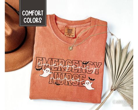 Emergency Nurse Halloween Shirt, Comfort Colors® ER Nurse Tech Shirt, ER Nurse Halloween Tshirt, Emergency Department RN, Spooky Nurse Tee About - Comfort Colors 1717 Crewneck Tshirts - 100% Ring-Spun Cotton - Relaxed Fit, Unisex Sizing - Direct to Garment (DTG) Printed - Ink is printed directly onto the item which results in a long lasting, slightly distressed look.  Care - For best care, we recommend apparel is machine washed cold (not exceeding 90 F) inside out. - Hang dry is recommended, or Nurse Tech, Nurse Halloween Shirt, Momma Shirts, Emergency Nurse, Nurse Halloween, Holiday Clothes, Emergency Nursing, Er Nurse, Halloween Nurse