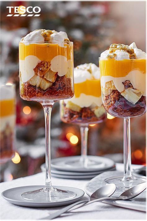 Finish off Christmas dinner with this tropical trifle recipe for something a little different. With layers of ginger wine-soaked ginger cake, roasted pineapple and sweet mango, this easy trifle recipe is sure to impress. | Tesco Trifle Cake Layered, Tropical Christmas Dinner, Classic Christmas Trifle, Gingerbread Trifle Christmas, Summer Christmas Dessert, Tropical Trifle, Chocolate Orange Trifle, Trifle Food Photography, Hoho Trifle