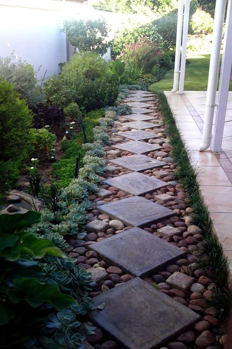 This square shaped concrete pavers on the garden stones add dignity and an easy way to prevent the pathway from getting wet. This space is ideal to have outdoor gatherings.#walkwaydesign   #walkwayidea  #walkwayideas  #gardenwalkway Rock Pathway, Side Yard Landscaping, Walkway Design, Gravel Garden, Garden Walkway, Rock Garden Landscaping, Stone Path, Urban Gardening, Garden Pathway