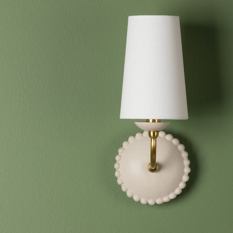 Refreshingly retro, Rhea captures the grandmillennial style. Using ceramic in antique ivory, as opposed to a brighter pure ivory, gives the fixture a warm, natural vibe and the sphere accents at the edges create a pretty scalloped look. The white linen shade and aged brass accents work perfectly with this subtle yet chic design. *Fixture may only be installed as shown in picture. Grandmillennial Style, Sconces Bathroom, Bathroom Sconces, Sconces Bedroom, Big Girl Rooms, Brass Accents, Lighting Inspiration, Light Wall, Aged Brass