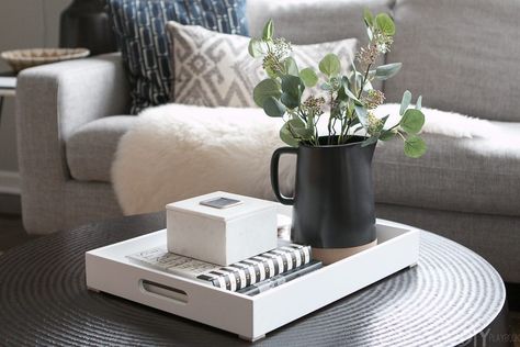 Tips to Style a Round Coffee Table in your Living Room | The DIY Playbook Trays On Ottomans Ideas, Black Coffee Table Decor, Style A Round Coffee Table, Black Round Coffee Table, Styling A Coffee Table, Living Room Tray, Coffee Table Crate And Barrel, Coffee Table Decor Tray, Black Coffee Table