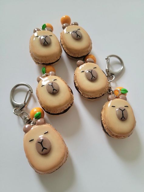 cute capybara macaron keychain with tiny orange charm! handsculpted with polymer clay and sealed with resin for gloss and durability. 6 available and then made to order. Macaron Keychain, Capybara Keychain, Chocolate Macaron, Cute Capybara, Clay Keychain, Tanah Liat, Clay Charms, Wedding Shop, Macarons