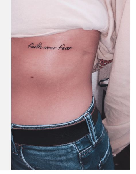 Faith Over Fear Rib Tattoo, Christian Rib Tattoos For Women, Faith Over Fear Tattoo For Women, Beautiful Tattoos For Women Unique, Faith Over Fear Tattoo, Fear Tattoo, Minimalist Tattoo Meaning, Tattoo Over Scar, Biblical Tattoos