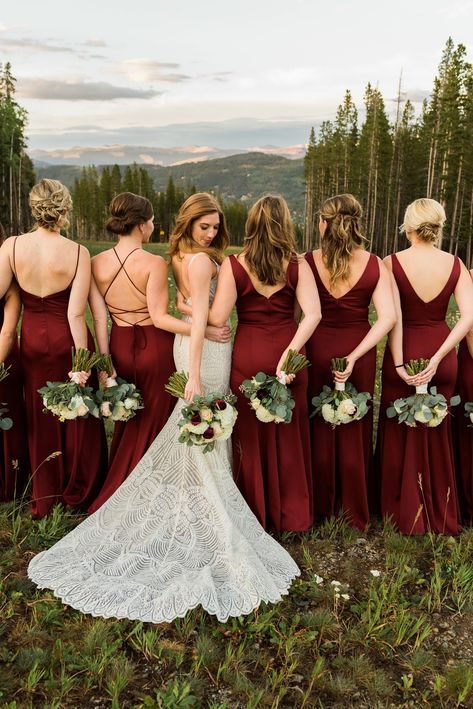 Love the different style of maroon bridesmaids dresses this group of women wore. They carried bridesmaid bouquets with white, pink, and maroon flowers. To see more of this TenMile Station wedding in Breckenridge check out the blog! Maroon And Pink Rustic Wedding, Red And Gold Wedding Bridesmaid Dresses, Claret Wedding Colors, Maroon Wedding Theme Bridesmaid Dress, Wine Red Bridesmaid Dress, Marron Bridesmaid Dresses Long, Braidmaids Dress Red, Champagne And Red Wedding Decorations, Rustic Red Bridesmaid Dresses