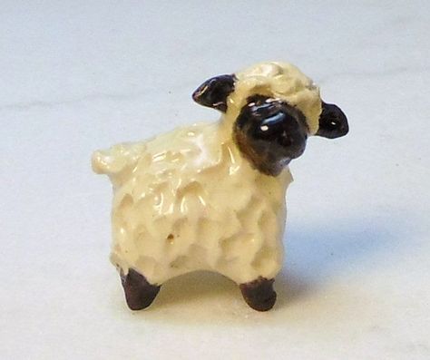 "Here is one sheep or lamb terrarium miniature figurine. It has been painted with black under glaze on the face ears and legs. Then clear gloss glaze makes it shiny.  The little lamb was  Individually sculpted without the use of molds from white stoneware clay.  I will choose your sheep with black face for you from my studio. Every little sheep is individually made and are a little different. I like to give these as thinking of you, get well or sympathy gifts. I think they are sweeter than flowe Clay People, Sheep Art, Miniature Figurine, Ceramic Figurine, Clay Figurine, Clear Gloss, Clay Animals, Pottery Crafts, Ceramic Animals