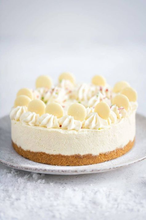 This Christmas Cheesecake is the perfect last-minute festive dessert. An easy no-bake white chocolate cheesecake recipe with a crunchy gingersnap base topped with deliciously creamy filling. No Bake White Chocolate Cheesecake, White Cheesecake, White Chocolate Cheesecake Recipes, Cake Cones, Baked White Chocolate Cheesecake, British Bake Off Recipes, White Chocolate Desserts, No Bake Cheesecake Filling, Chocolate Cheesecake Recipe