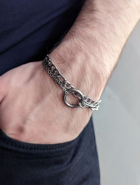 1st photo shows a fragment of a man's hand, tucked into his pocket. He is wearing an o-ring bracelet on his wrist. 2nd photo shows a close-up of the same bracelet on a hand. Ring Centrepiece, Grunge Jewellery, Jamie Tartt, Multi Chain Bracelet, Day Collar, Grunge Jewelry, Alternative Jewelry, Wear Necklaces, Relationship Stuff