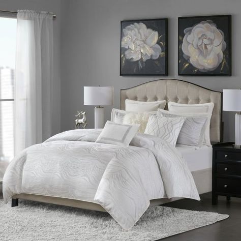 Add a modern and elegant update to your bedroom with the Monroe bedding collection. The oversized and overfilled comforter flaunts metallic details and two shams mirror the glamorous look. The euro shams feature velvet and embroidered detailing while the decorative pillows are embellished with un... Glam Bedding Sets, Glam Comforter Set, Glam Bedding, White Comforter, Bob's Discount Furniture, Ideas Hogar, American Signature Furniture, Value City Furniture, King Comforter Sets