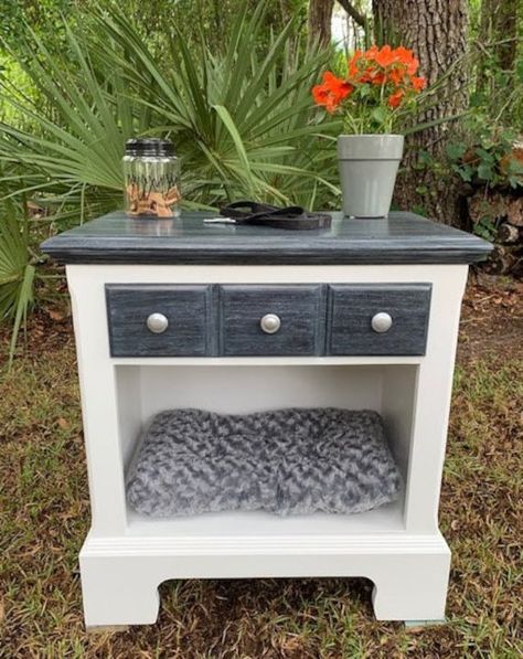 This oak table has been made into a bed for your small pet with a drawer to hold supplies or toys.  It can also be used as an end table, side table or nightstand.  The new pet bed and drawer mat are included, however, the other items in the photo are not.  The base has been hand-painted white while the drawer front and top were stained black, white-washed and sealed.    Approximate measurements are as follows:   Table - 25 3/4" wide x 28" tall x 16" deep. Pet sleep area - 22 1/2" wide x 12 1/4" Dog Beds Made From Furniture Repurposed, Cat Bed End Table, Night Stand Dog Bed, Dog Bed Furniture End Tables, Dog Bed Night Stand, End Table Pet Bed, End Table Dog Bed, Cats Room, Nyc Room