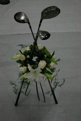 golf club flower arrangement | Kelly, our Pastor’s wife, asked us for three of Gus’ golf clubs ... Golf Table Decorations, Golf Centerpieces, Praise Music, Grave Flowers, Golf Decor, Cemetery Decorations, Tiffany Wedding, Popular Flowers, Cemetery Flowers