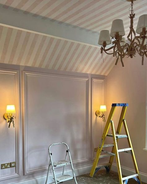 Stephanie Moreton on Instagram: "CANDY STRIPES 💕 As soon as I saw this vaulted ceiling I knew I wanted to wallpaper the whole area!! Thankfully the client loved the idea as much as me!!! …this is going to be something special….lots more to add including custom blinds 💕 . . . . . #pink #pinkbedroom #girlsbedroom #girliebedroom #stripedwallpaper #walllights #chandelier #panelling #wallpanelling #bedroom #bedroominspo #design #designinspo #designservice #homedesign #homeinspo #beverleyhillshotel Pink Ceiling White Walls, Wainscoting Slanted Ceiling, Angled Ceiling Wallpaper, Wallpaper On Slanted Ceiling, Vaulted Ceiling Wallpaper, Nursery Ceiling Wallpaper, Painted Ceiling Kids Room, Wallpanelling Bedroom, Striped Wallpaper Ceiling