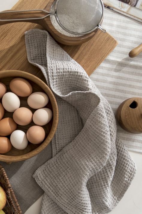 Table with kitchen tools, bowl of eggs and tea towel from waffle linen in oatmeal color. Kitchen Towel Photography Ideas, Kitchen Towel Photography, Waffle Fabric Ideas, Tea Towel Photography, Kitchen Towel Gift Ideas, Towel Gift Ideas, Embroidery Kitchen Towels, Kitchen Towel Gift, Modern Kitchen Towels