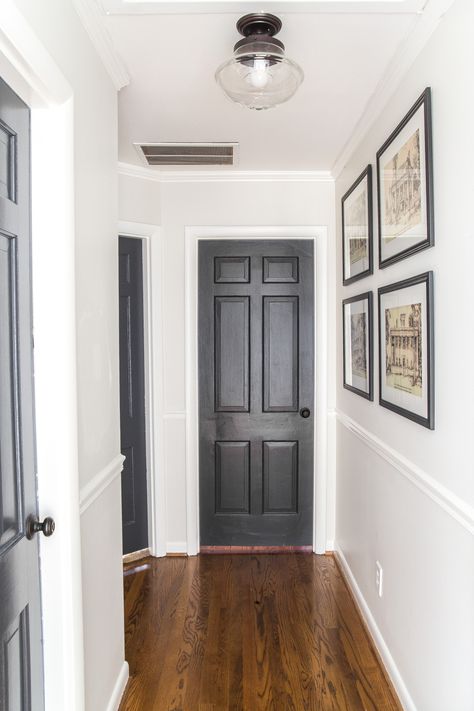 Black Interior Doors Grey Walls, Black Interior Doors White Walls, Black Doors Interior Before And After, Wrought Iron Interior Doors, Hallway Black Doors, White Walls Black Doors, Wrought Iron Benjamin Moore, Black Doors Interior, Painted Panelling