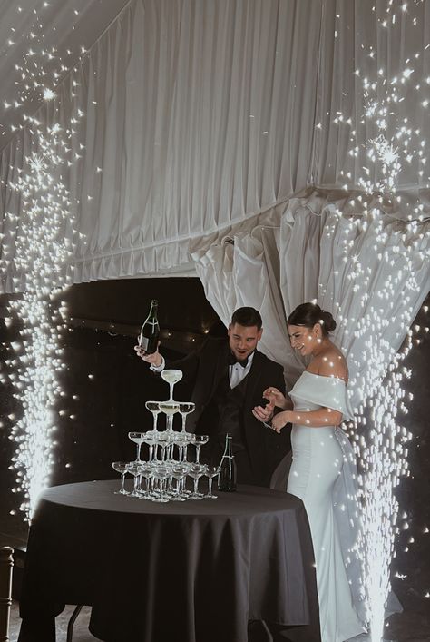 Champagne tower, wedding, sparkler exit Champagne Glass Tower Wedding, Champagne Wedding Tower, Indoor Fireworks Wedding, Wedding Champaign Tower, Wedding Themes Champagne, Champagne Pour Wedding, Trendy Wedding Decor 2023, Champagne Aesthetic Wedding, Champagne Fountain Wedding