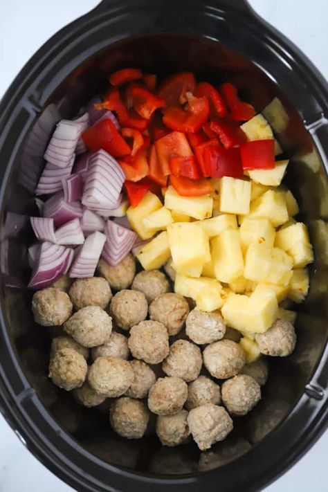 This Sweet and Sour Meatballs recipe is an easy slow cooker meal that works equally well as an appetizer or as a main course. They’re made with either frozen or fresh meatballs, and covered in a delicious sweet and sour sauce along with pineapples, onions, and peppers. #thecarefreekitchen #meatballs #sweetandsour #asian #pineapple #easydinner #crockpot #slowcooker #appetizer Meatballs With Peppers And Onions, Pineapple Meatballs Crockpot, Sweet And Sour Meatballs With Pineapple, Chicken Pineapple Meatballs, Meatball Pineapple Smokies, Sweet And Sour Meatballs Crockpot, Fresh Meatballs, Frozen Meatballs Crockpot, Sweet And Sour Meatballs Recipe